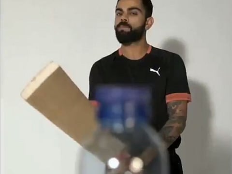 Virat Kohli braces up for the Bottle Cap challenge in the video.