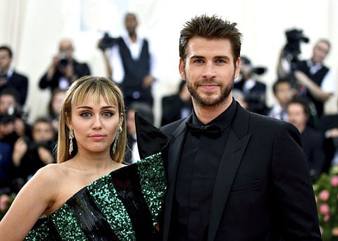Miley Cyrus, left, and Liam Hemsworth attend The Metropolitan Museum of Art's Costume Institute benefit gala celebrating the opening of the "Camp: Notes on Fashion" exhibition on Monday, May 6, 2019, in New York. (Photo by Charles Sykes/Invision/AP)