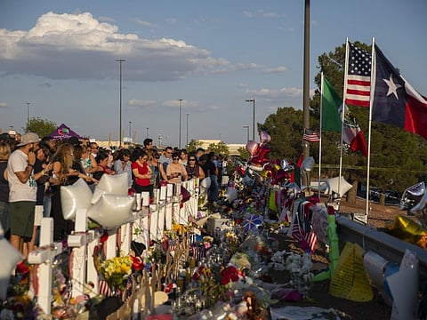 People gather at a makeshift memorial for victims of a mass shooting at a Walmart in El Paso, Texas, on August 6, 2019.