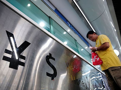 Spreading the wealth around requires the right sort of tech support. File photo of the yuan and dollar signs at a currency exchange outlet in China.