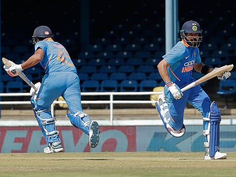 India captain Virat Kohli, right, and Rohit Sharma, run between the wickets during their second One-Day International cricket match against West Indies in Port of Spain, Trinidad, on August 11, 2019.