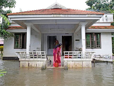 A woman clears out the water from her flooded house at Paravur on the outskirts of Kochi, in the southern state of Kerala, India August 11, 2019.