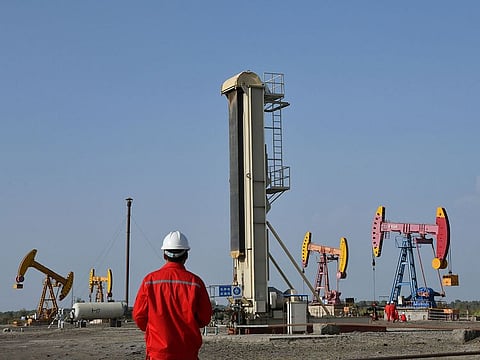 Workers are seen near pumpjacks at a China National Petroleum Corp (CNPC) oil field in Bayingol. Oil markets on Friday closed on their first weekly high in a month, with Brent trading at $26.44 and West Texas Intermediate (WTI) on $19.78, as prices flickered with some good news on Opec+ production cuts of almost 10 million barrels per day (bdp) coming into effect.