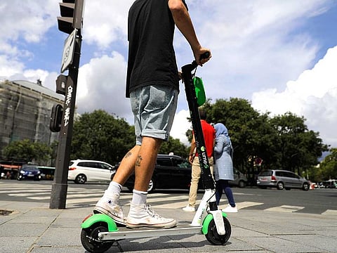 A man rides an electric scooter in Paris in this file picture.