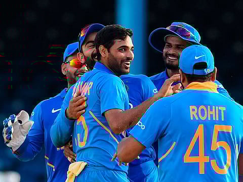 Bhuvneshwar Kumar (C) of India celebrates the dismissal of Roston Chase (not pictured) of West Indies during the 2nd ODI match at Queens Park Oval in Port of Spain, Trinidad and Tobago, on August 11, 2019.