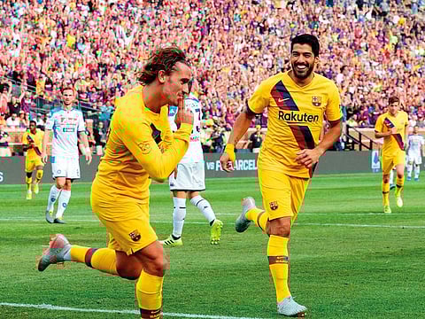 FC Barcelona's Luis Suarez (right) celebrates his goal with teammate Antoine Griezmann during the second half of the La Liga-Serie A Cup match between FC Barcelona and SSC Napoli on August 10, 2019 at Michigan Stadium in Ann Arbor, Michigan.