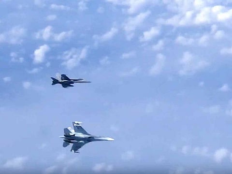 In this video grab taken from a footage on Aug. 13, 2019, and distributed by Russian Defense Ministry Press Service, a Russian air force's Su-27 fighter jet, bottom, maneuvers to ward off a NATO F-18 warplane over the Baltic Sea