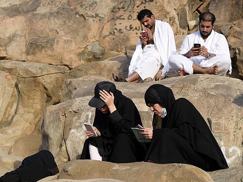 AFP
Pilgrims use their smartphones on Mount Arafat on Arafat Day. Thanks to 5G, many pilgrims snapped selfies over the five-day ritual and sent video clips to friends and family back home.