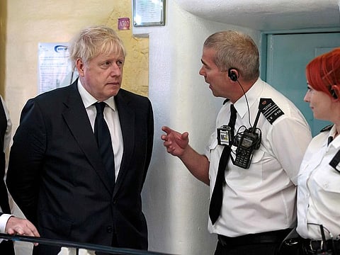 Britain's Prime Minister Boris Johnson talks with prison staff during a visit to HM Prison Leeds, a Category B men's prison in Leeds, northern England.