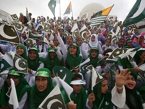 Pakistani students wave Pakistani and Kashmiri flags at the mausoleum of Muhammad Ali Jinnah, founder of Pakistan, to celebrate the Independence Day in Karachi, Pakistan, on Wednesday, August 14, 2019. Pakistanis commemorated their independence from British colonial rule in 1947.