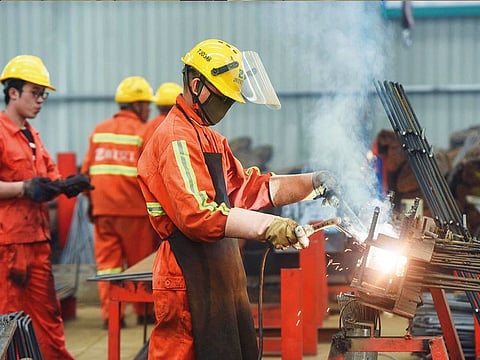 Staff working on rebars at a factory in Hangzhou in China. Chinese factory output data was the weakest in 17 years.