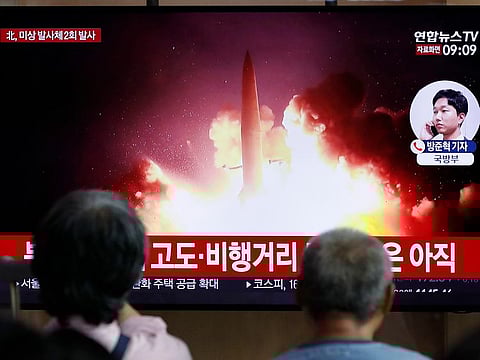 People watch a TV news program reporting about North Korea's firing projectiles with a file image at the Seoul Railway Station in Seoul, South Korea, Friday, Aug. 16, 2019.