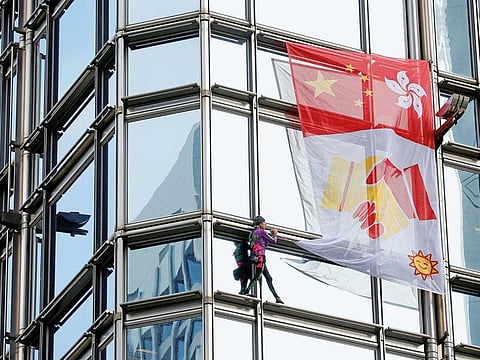 French urban climber Alain Robert climbs the Cheung Kong Center building in Hong Kong.