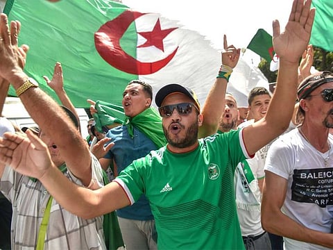 Algerian protesters take part in a demonstration against the ruling class in Algeria's capital Algiers.