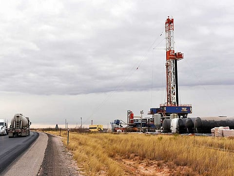A drilling rig operates in the Permian Basin in Lea County, New Mexico. Permian oil production had also surged beyond pipeline takeaway capacity.