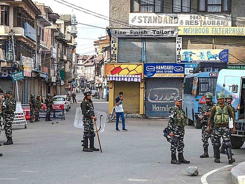 Security personnel stand guard during restrictions following the abrogation of the provisions of Article 370, in Srinagar