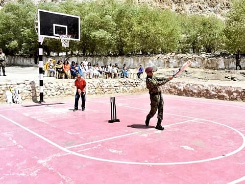 Dhoni is seen hitting the ball.
