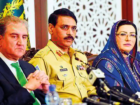 From left: Qureshi, Ghafoor and information Minister Firdous Ashiq Awan listens a question during a press conference at the foreign ministry in Islamabad.