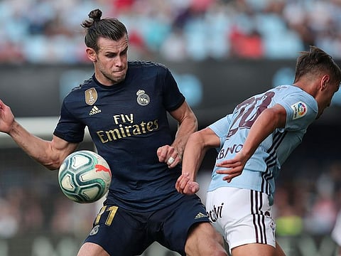Real Madrid's Gareth Bale, left, challenges for the ball with Celta Vigo's Kevin Vazquez during the La Liga soccer match at the Balaídos Stadium in Vigo, Spain, on Saturday.