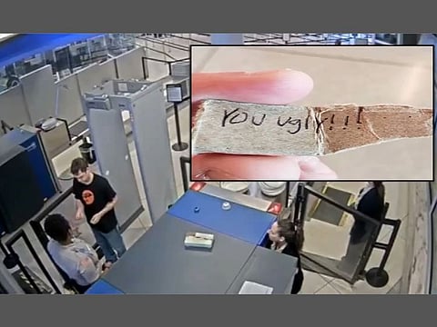 The video from Greater Rochester International Airport shows the worker handing Strassner the note after he passes through a metal detector.