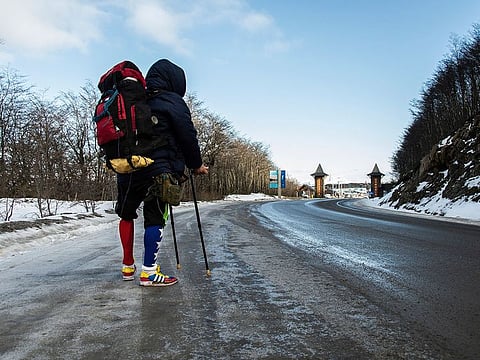Venezuelan Yeslie Aranda, 57, stands at the entrance of Ushuaia, Argentina, the southernmost city in the world, as he makes good on his promise to travel throughout South America with one leg and a prosthesis.