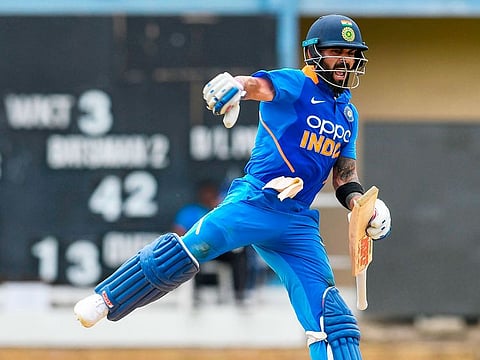 Virat Kohli celebrates his century during the 2nd ODI match against West Indies at Queens Park Oval in Port of Spain, Trinidad and Tobago, on August 11, 2019.