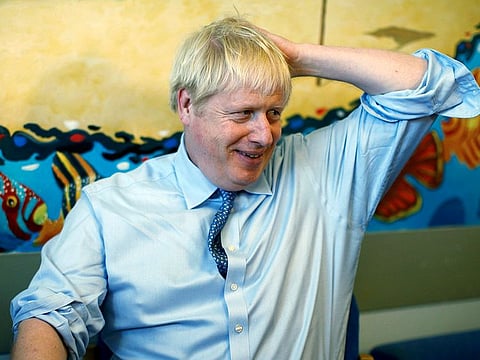 Britain's Prime Minister Boris Johnson speaks with staff during a visit to the Royal Cornwall Hospital in Truro, south-west England, Monday Aug. 19, 2019.