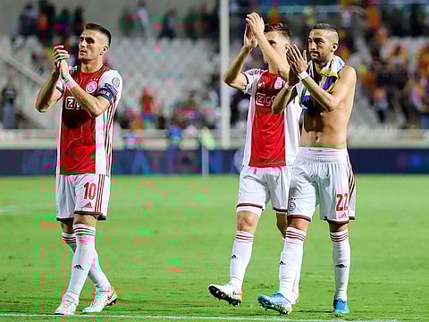 Ajax's players greet their supporters.