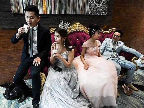 Couples wait for their pre-wedding photo shoot at the Love Story in Rome Studio in Beijing.
