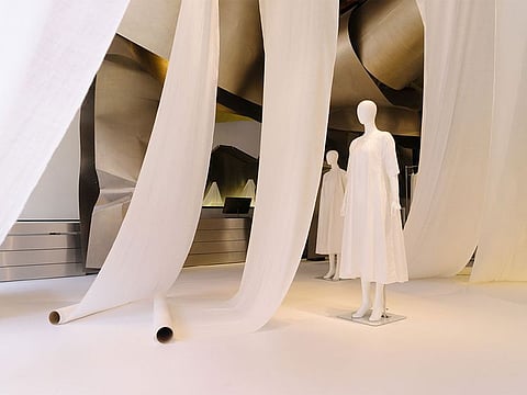 Issey Miyake's store features an elegant white space draped in rolls of Khadi cloth, and mannequins in Khadi outfits.