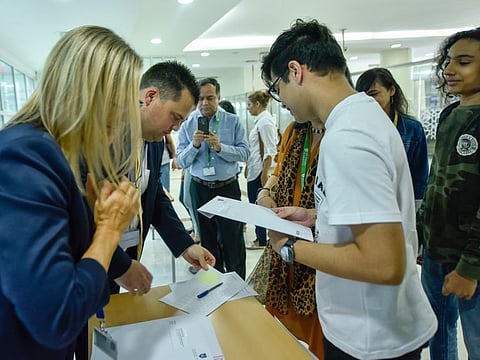 Students and parents at GEMS Wellington International School in Dubai on Thursday.