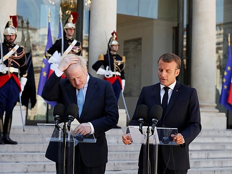 British Prime Minister Boris Johnson and French President Emmanuel Macron deliver a joint statement before a meeting on Brexit at the Elysee Palace in Paris.