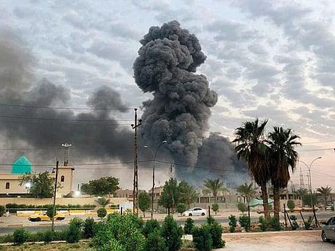 Plumes of smoke rise after an explosion at a military base, southwest of Baghdad, earlier this month. A fact-finding committee appointed by the Iraqi government has concluded that the blast at a munitions depot was the result of a drone strike.
