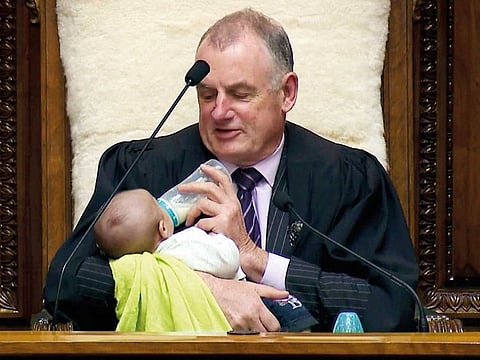 New Zealand House Speaker Trevor Mallard bottle-feeds lawmaker Tamati Coffey's baby