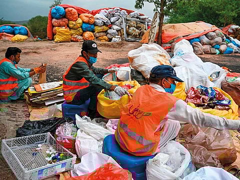 Municipal workers sort out recycling items in Islamabad.