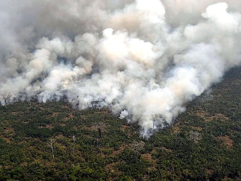 Aerial picture showing smoke from a two-kilometre-long stretch of fire billowing from the Amazon rainforest about 65 km from Porto Velho, in the state of Rondonia, in northern Brazil.