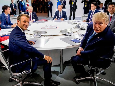 France's President Emmanuel Macron (L) and US President Donald Trump attend a working session on "International Economy and Trade, and International Security Agenda" in Biarritz, south-west France on August 25, 2019, on the second day of the annual G7 Summit attended by the leaders of the world's seven richest democracies, Britain, Canada, France, Germany, Italy, Japan and the United States.