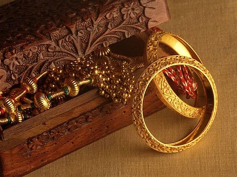 Gold prices eased on Monday as traders awaited December US inflation data that could stress the need for earlier-than-anticipated interest rate hikes by the world's largest economy.