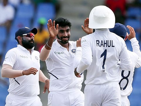 India's Jasprit Bumrah celebrates taking the wicket of West Indies' Darren Bravo during day four of the first Test cricket match at the Sir Vivian Richards cricket ground in North Sound, Antigua and Barbuda, on August 25, 2019.