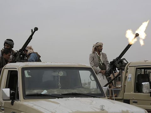 A Houthi rebel fighter fires in the air in Sanaa, Yemen.