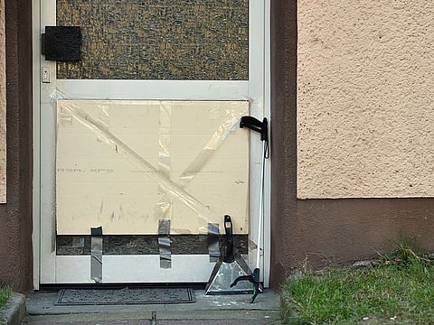 A dust pan and a gripper are pictured in front of an evacuated apartment building in Herne, Germany, Aug. 26, 2019.