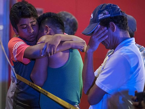 People react outside a bar where 23 people were killed by a fire in Coatzacoalcos, Veracruz, on August 28, 2019.  At least 23 people were killed and 13 badly wounded in a fire at Caballo Blanco bar (White Horse bar) in eastern Mexico that is being investigated as an attack according to Mexican authorities.