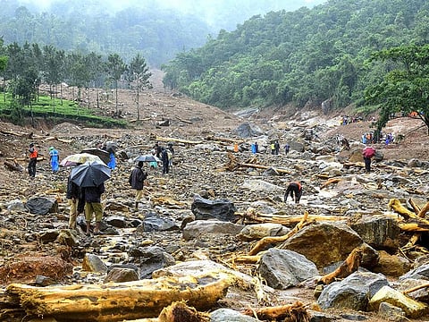 Volunteers, local residents and members of National Disaster Response Force (NDRF) search for survivors in the debris left by a landslide at Puthumala at Meppadi in the Wayanad district of the Indian state of Kerala on August 10. Floods have killed at least 100 people and displaced hundreds of thousands across much of India with the southern state of Kerala worst hit, authorities said on August 10.
