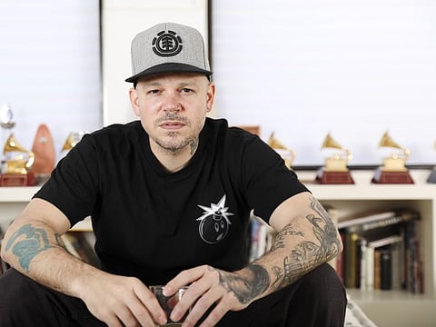This July 12, 2019 photo shows Puerto Rican rapper, writer, and filmmaker René Pérez Joglar, known professionally as Residente, at his home in New York. Residente studied intensely with professors at Yale University and New York University to create his second solo project. The untitled album will be released in November. (Photo by Brian Ach/Invision/AP)