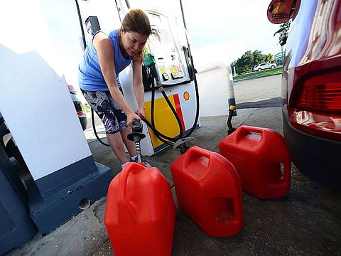 A resident fills petrol cans in preparation for Hurricane Dorian on August 29, 2019 in Winter Springs, Florida.