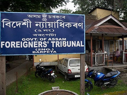 In this August 28, 2019, photo, people wait at the Foreigner's Tribunal office in Barpeta, in the northeastern Indian state of Assam, India.