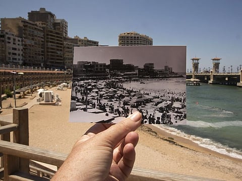 This Aug. 10, 2019 photo, shows Stanley Beach in Alexandria, Egypt, at the same site of a 1933 photograph, foreground. Alexandria, which has survived invasions, fires and earthquakes since it was founded by Alexander the Great more than 2,000 years ago, now faces a new menace from climate change.