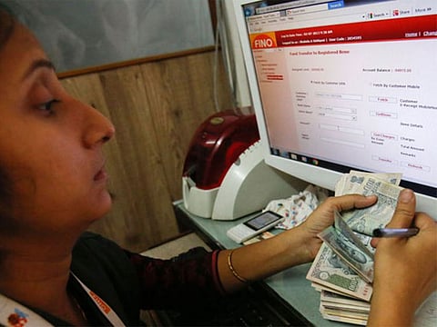 A teller counts a bundle of Indian Rupee currency notes. Optimism over the development of Covid-19 vaccine along with broad-based growth trends is expected to induce volatility in the rupee’s value during the short term.