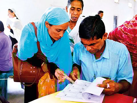 People check their names on the final list of the National Register of Citizens at Buraburi village in Assam.