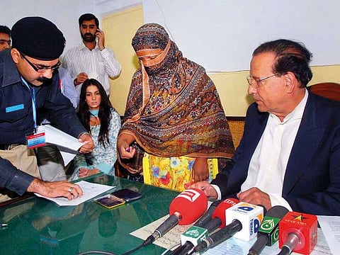 A police official takes the thumb print of Asia Bibi during a visit from Governor Salman Taseer at the central jail in Sheikhupura. Bibi said her wrongful conviction after she was accused of insulting the Prophet Mohammad (PBUH) in a row with fellow farmhands had devastated her life.